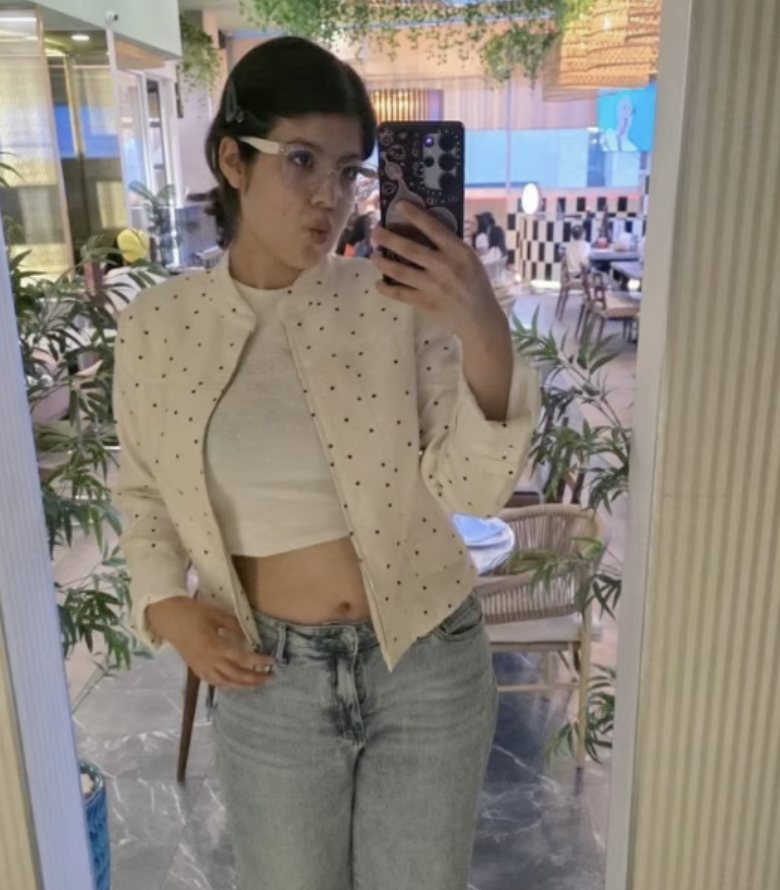 Mirror selfie in a cream jacket